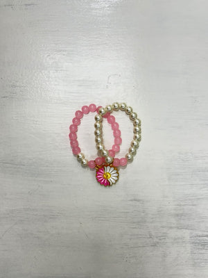 Double Pearls Bracelet featuring pink and silver-tone beads with a decorative pink and white flower charm
