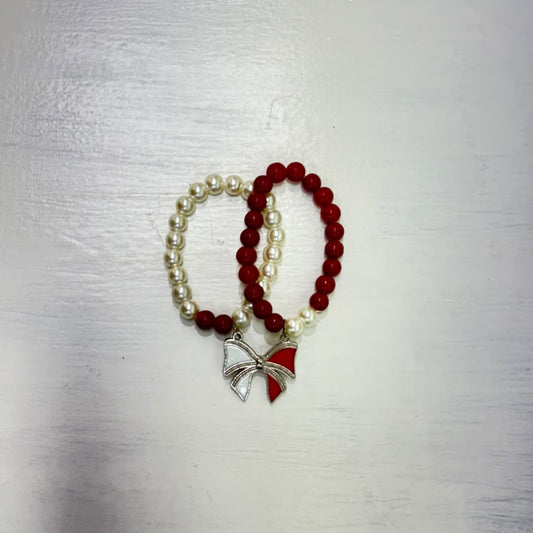 Double pearl bracelet with red and ivory beads and decorative bow charm