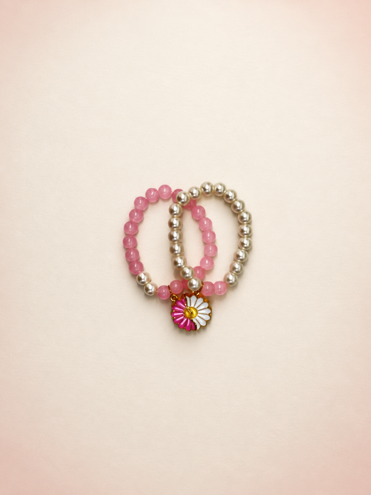 Double Pearls Bracelet with pink and silver-tone beads and a pink-white flower charm, AI-assisted studio image